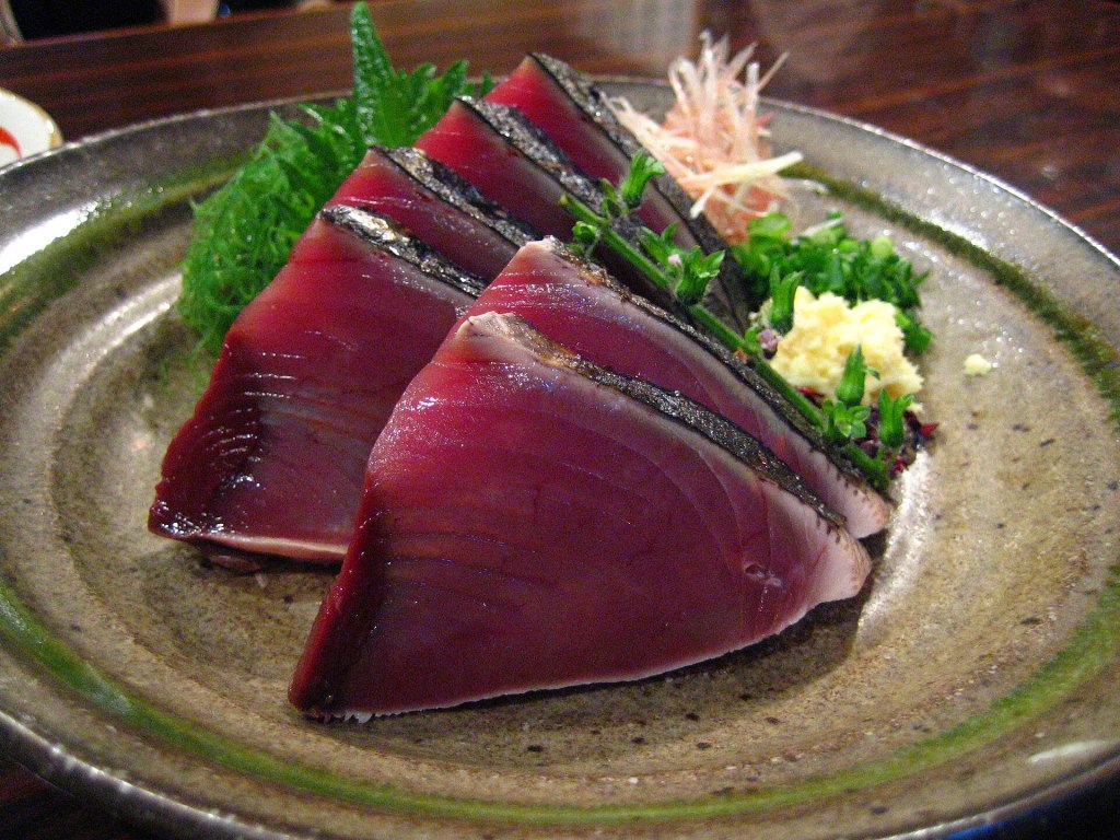 Slices of katsuo no tataki, seared bonito, on a plate