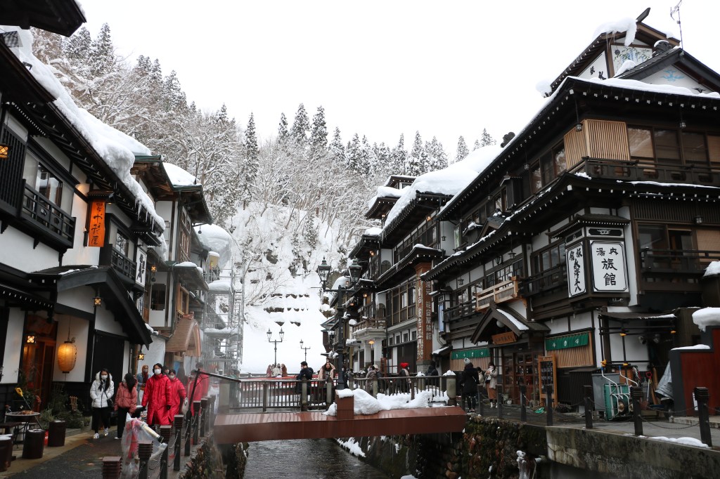 Wooden ryokan buildings along the river at Ginzan Onsen