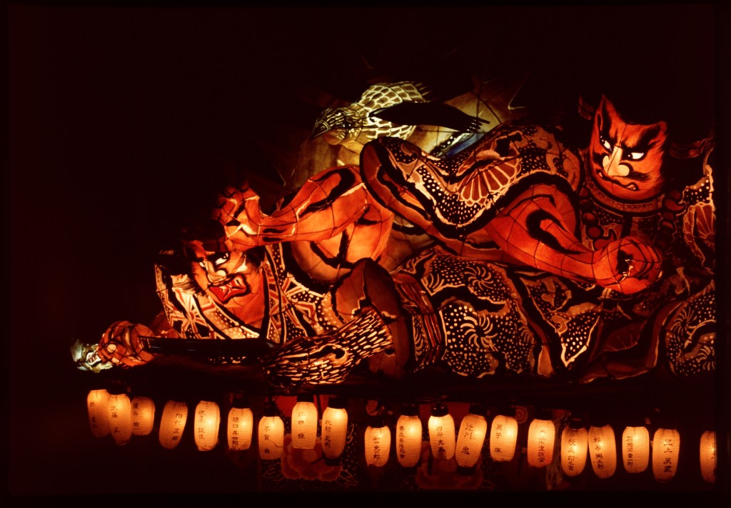 An illuminated Nebuta float carried through the streets of Aomori in August