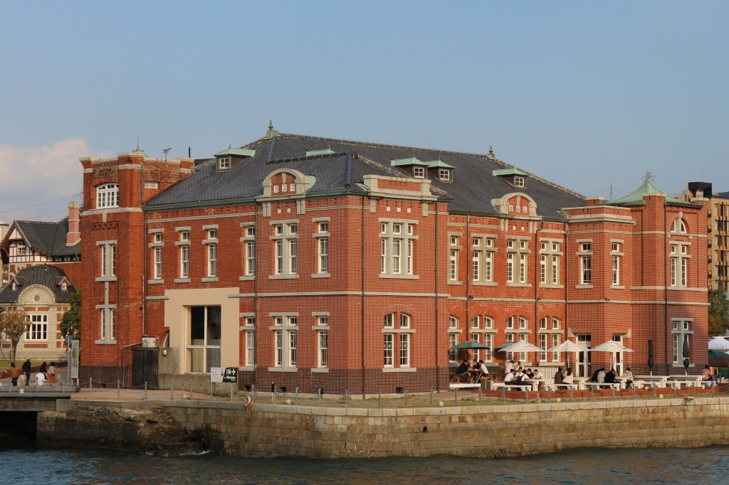 Red brick former Moji Customs building with its square tower on the waterfront