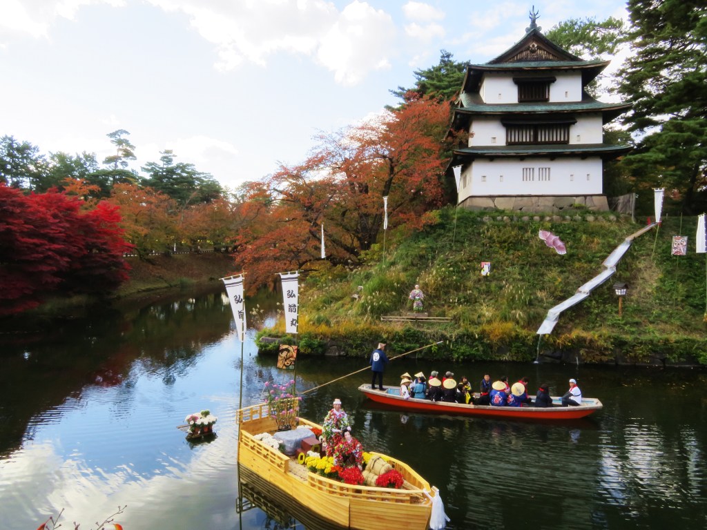 Chrysanthemums and autumn leaves at Hirosaki Castle in Aomori, Japan