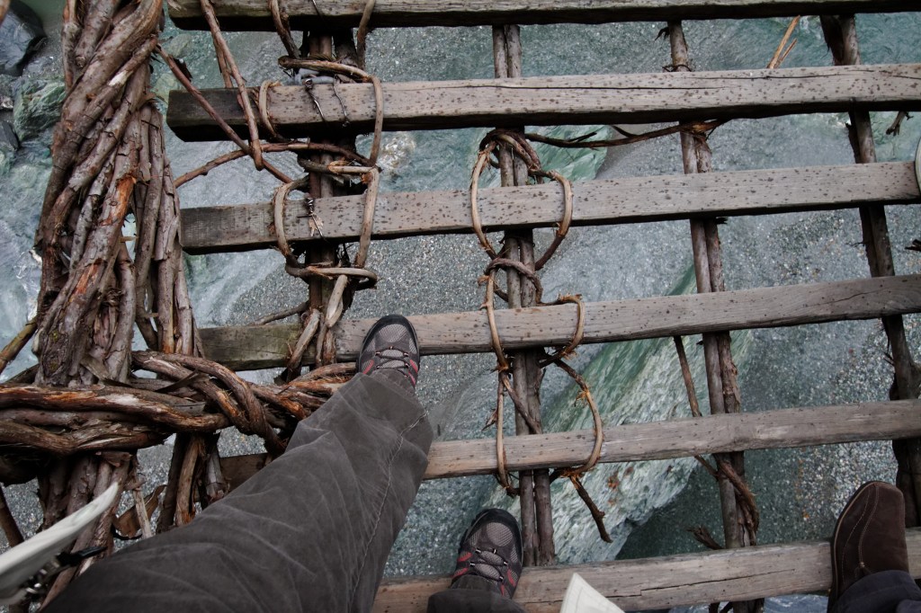 Vine-and-plank deck of the Iya vine bridge, seen from standing on the bridge