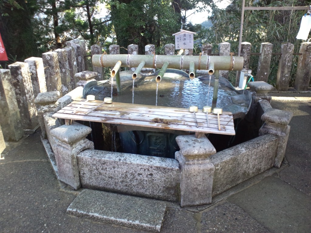 Stone water basin at Kumano Nachi Taisha with bamboo ladles
