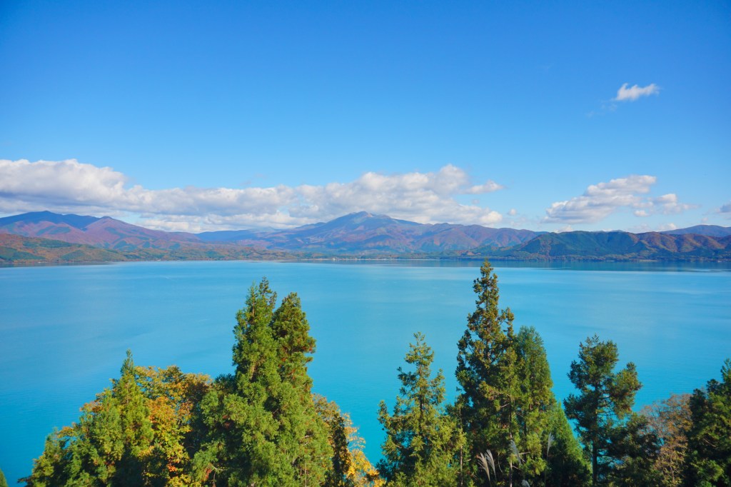 The shore of Lake Tazawa with forested hills behind