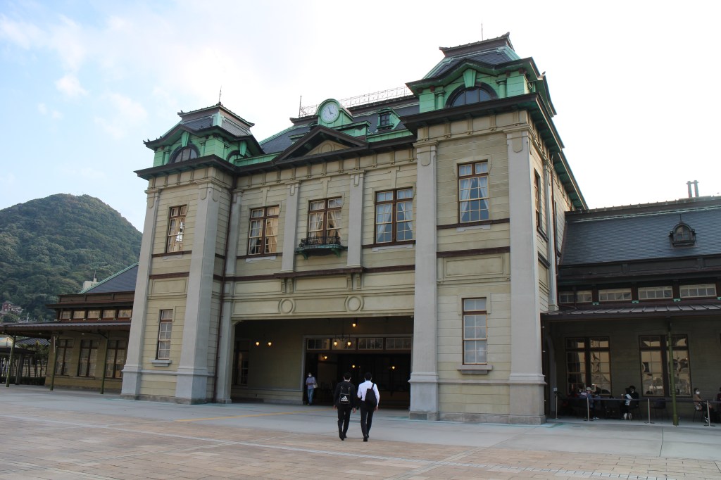 Symmetrical cream-coloured facade of Mojiko Station in daylight