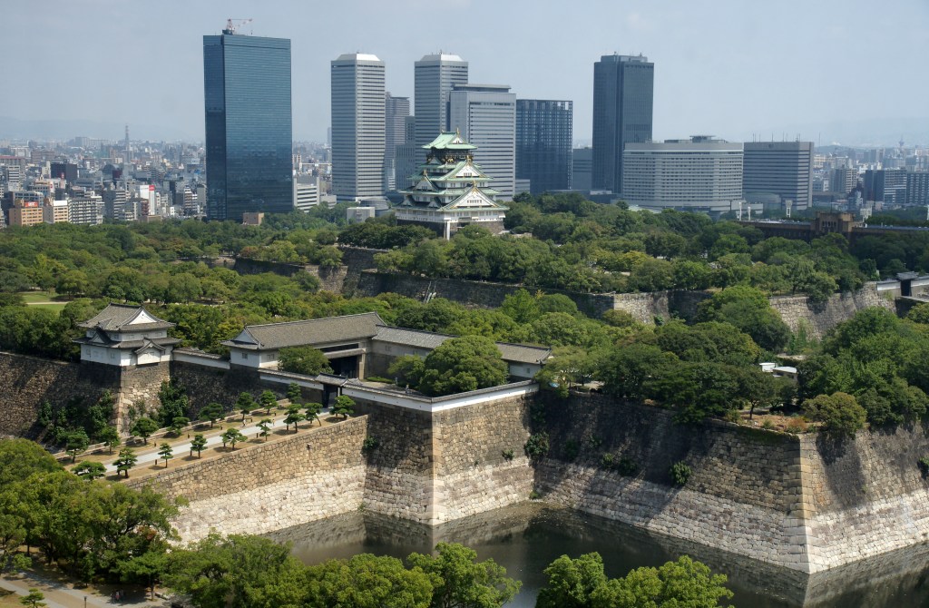 Osaka Castle keep rising above the stone walls and moat, Osaka, Japan
