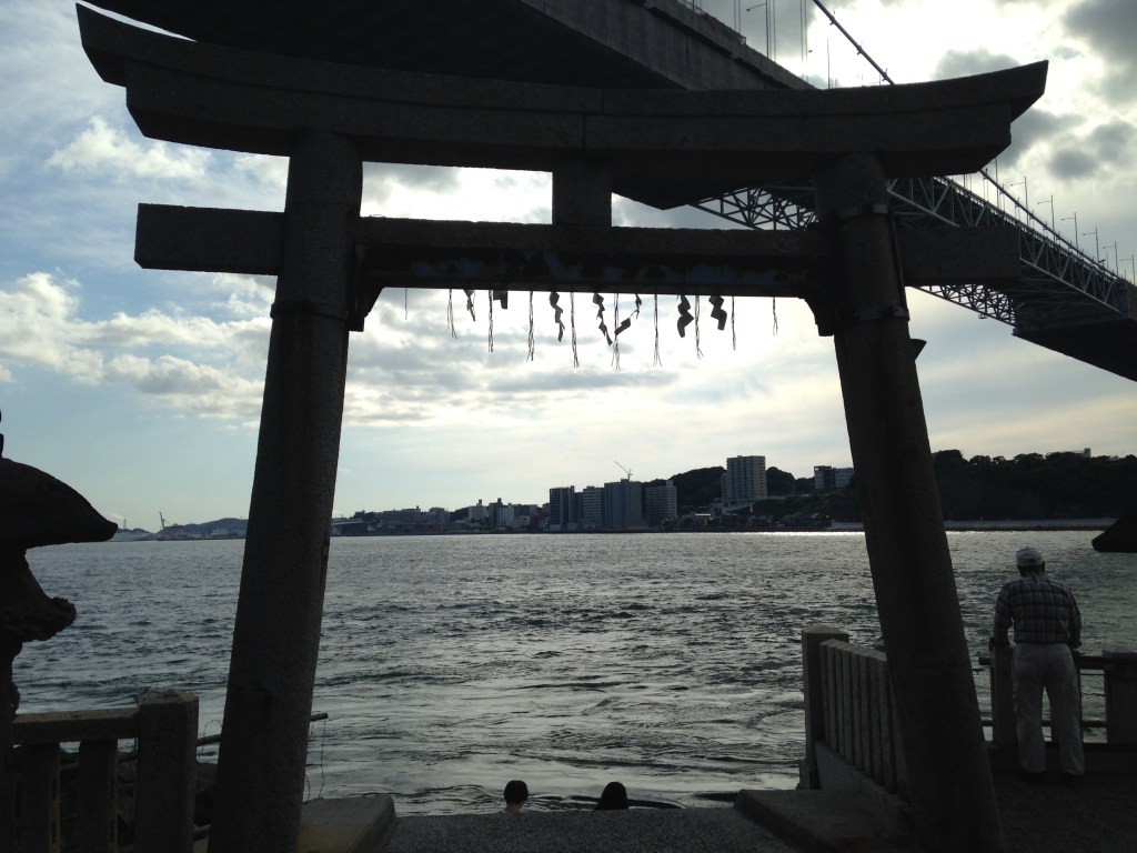 Seaside torii of Mekari Shrine with the Kanmon Bridge behind