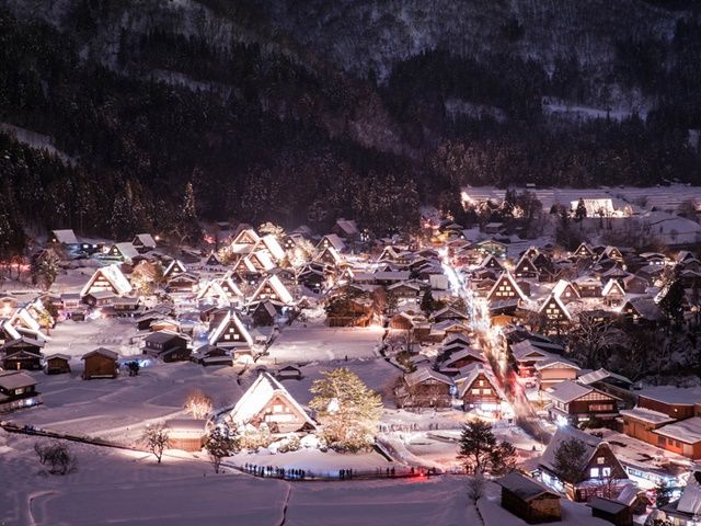 Illuminated gassho-zukuri houses in snow at Shirakawa-go after dark