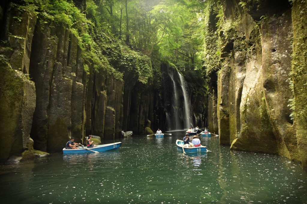 Rowboats on emerald water between cliffs at Takachiho Gorge, Miyazaki, Japan