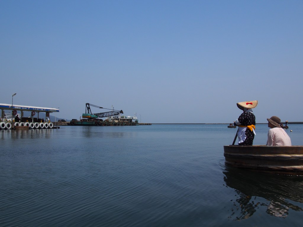 A traditional wooden tub boat, or taraibune, in the bay at Ogi on Sado Island, Niigata, Japan